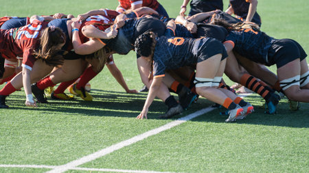 Tense moment of girls rugby fight . Dramatic challenging game for womens rugby team in match dayの写真素材