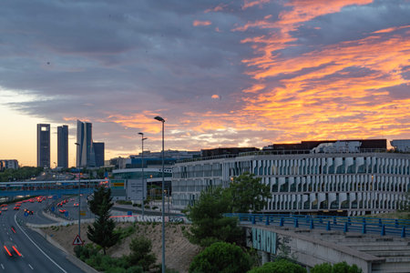 Madrid cityscape and four towers at sunset with red sunlight reflecting cloudsの写真素材