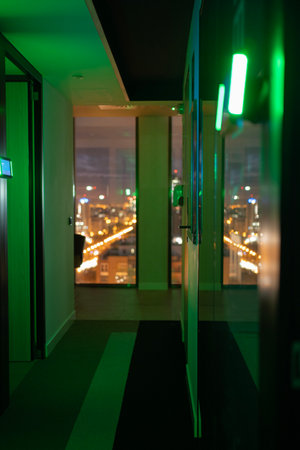 Futuristic office with city night lights reflection in the backgroundの写真素材