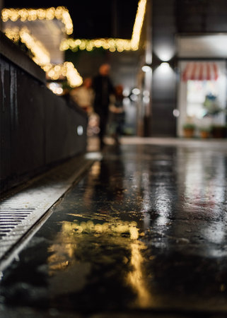 Christmas lights reflecting on wet ground - Blurred backgroundの写真素材