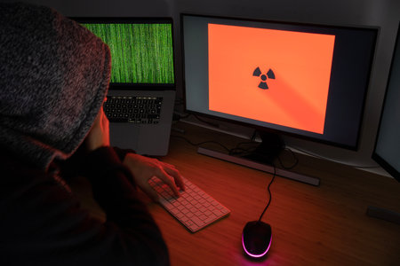 An anonymous male hacker use his skills to hack systems, personal data and money.cyber crime conceptの写真素材