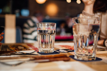 background blurred restaurant table setting with people enjoyingの写真素材