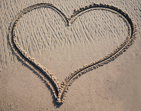 A big heart shape drawn in the sand with copy spaceの写真素材