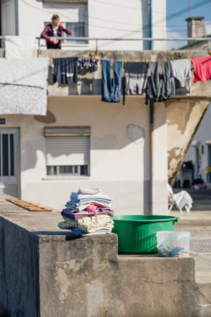 folded clothes in street after getting dried on a bright and sunny afternoon in Espinho , Portugalの写真素材