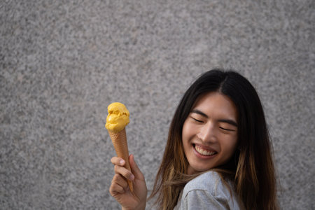 Happy gay male with a yellow ice cream and copy spaceの写真素材
