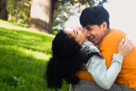 Young couple enjoy love in a park. Man and woman flirting and laughing in a parkの写真素材
