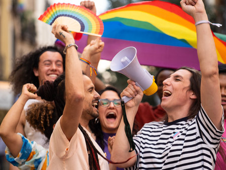 A group of homosexual people excited on an LGBTQ parade jumping and demanding for their rights.の写真素材