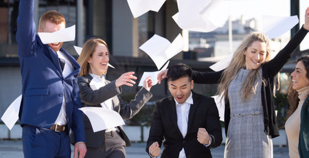 Multiethnic group of business people are excited celebrating success outdoors.の写真素材