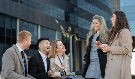 Multiracial business people enjoying a lunch break outdoor from office buildingの写真素材