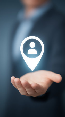 Businessman is holding a virtual location pin with person icon, symbolizing targeted marketing in the digital age.の写真素材