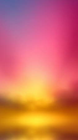 Blurred sunset with vibrant colors reflecting on water creates a stunning gradient aky background