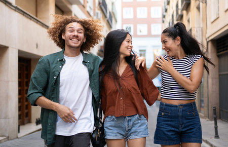 Happy multi-ethnic friends walking down the street of a city