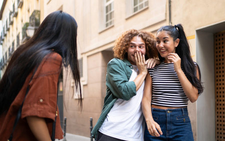 Group of friends meeting a girl in a city street, they are surprised and smiling