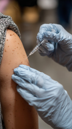 Close up of a doctor administering a vaccine injection into a patient's arm, highlighting the importance of vaccination for disease preventionの写真素材