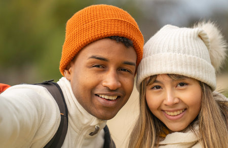 Headshot of young hikers taking a selfie while enjoying a hike in the colorful autumn forestの写真素材