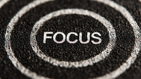 Focus word text on a black target background with white concentric ringsの写真素材