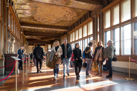 People are on the corridor of the Uffizi Gallery (1581), one of the oldest museums in Europe in...