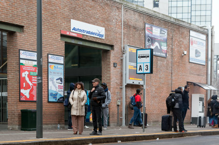 People are waiting for the bus at the city bus station stop. Milan. Italy