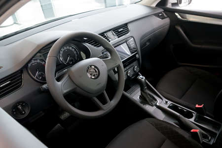 The front of the vehicle interior with a driver's seat, dashboard and steering wheel.のeditorial素材