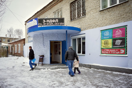 Novosibirsk, Novosibirsk region, RF - November 11, 2017: People are near the entrance to the district tax department with an electronic sign with the inscription in Russian - 3-NDFL.のeditorial素材