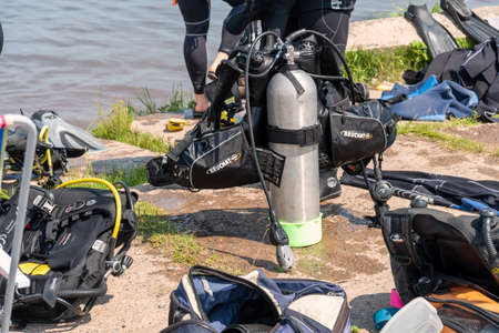 Parnaia, Sharypovskiy district, Krasnoyarsk region, RF - July 4, 2021: Scuba diving equipment with an oxygen tank in the center is located on the shore on a sunny summer day.のeditorial素材
