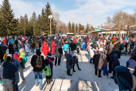 Krasnoyarsk, Krasnoyarsk Region, RF - March 14, 2021: A crowd of townspeople of different ages gathered on the square in the central park of the city during the Farewell to Winter holiday.のeditorial素材