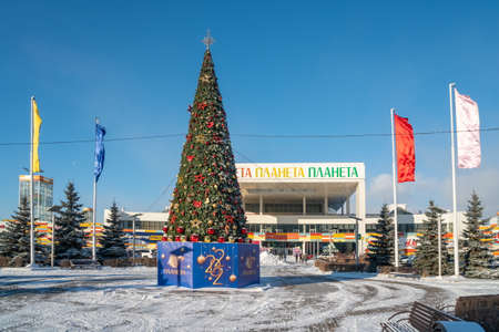 Krasnoyarsk, Krasnoyarsk Territory, RF - November 26, 2021: A decorated Christmas tree with the inscription Planet in Russian stands in front of the Planet shopping and entertainment center.のeditorial素材