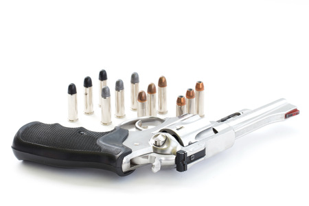 chrome gun  38 mm and bullets white backgroundの写真素材