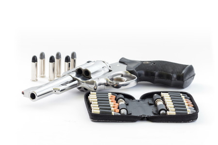 chrome gun  38 mm and bullets white backgroundの写真素材