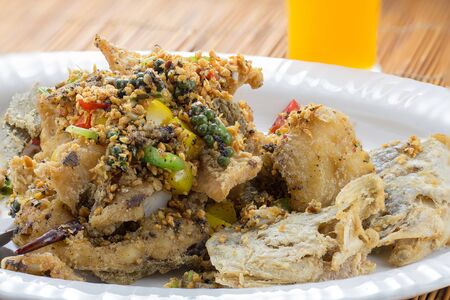 grilled Black Pepper Fish in white plate on wooden tableの写真素材
