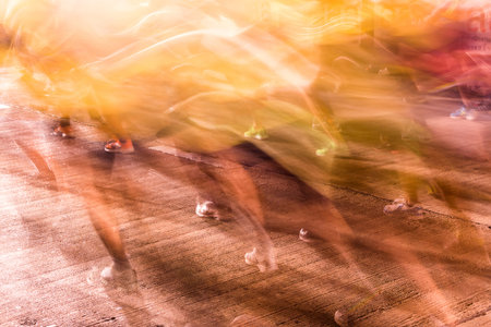 Runners running in city marathon, motion blur on sporty legsの写真素材