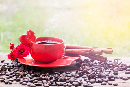 red roses and coffee cup on wooden table. Valentines day conceptの写真素材