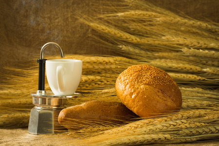 Bread still-life with coffeemaker, bread, wheatの写真素材