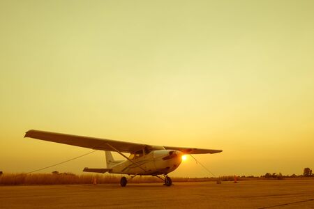 beautiful landscape image with old wing airplane at sunsetの写真素材
