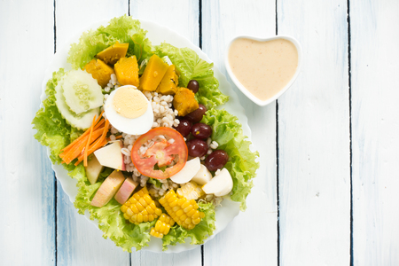 Fresh healthy salad on white wooden table. View from above with copy spaceの写真素材