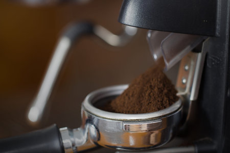 coffee grinder grinding freshly roasted make beans into a powderの写真素材