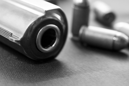 handgun with cartridge on the black backgroundの写真素材