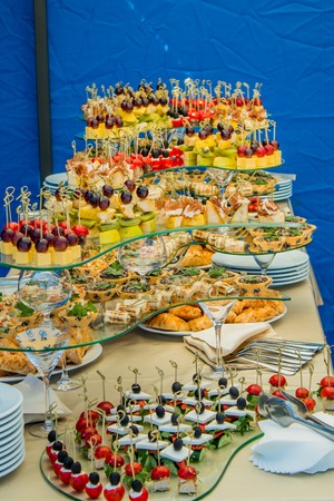 Assortment of canapes with meat, fruits and vegetables. Banquet service buffetの写真素材