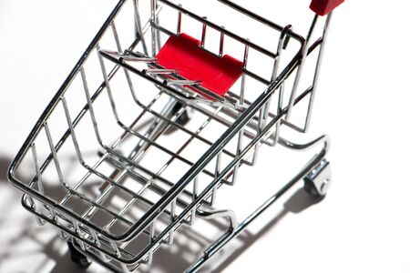 Empty shopping cart with red handle isolated on white, close upの写真素材