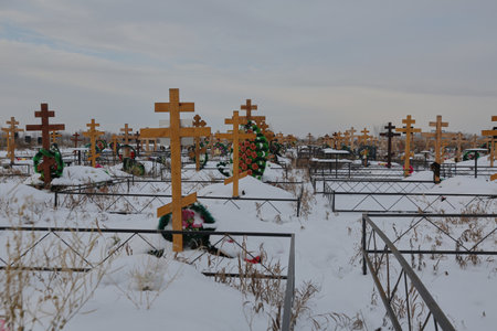 christian cemetery with wooden crosses in winterの写真素材
