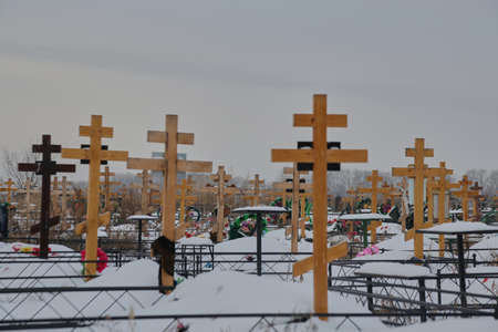 christian cemetery with wooden crosses in winterの写真素材