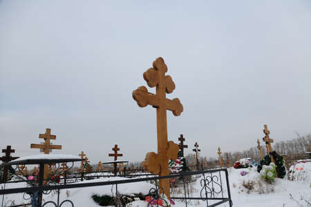 christian cemetery with wooden crosses in winterの写真素材