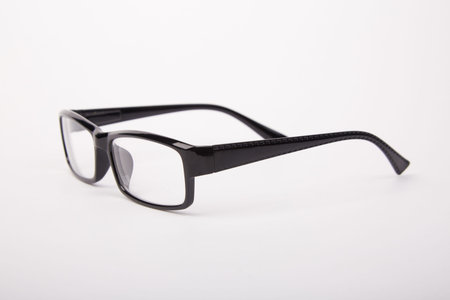 Stylish glasses with black frames on a white background