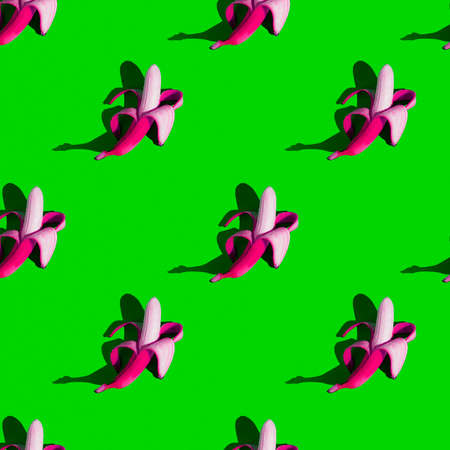 stylized seamless pattern of peeled pink bananas on a green background, unnaturalの写真素材
