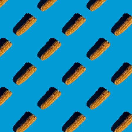 bright flat seamless pattern of peeled corn on a blue backgroundの写真素材