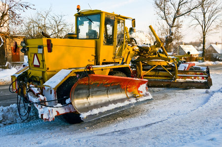 Grader removes snow from road 