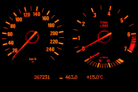 Glowing speedometer and tachometer isolated on black