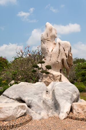 Park ancient stones decorated with flowers and plantsの写真素材