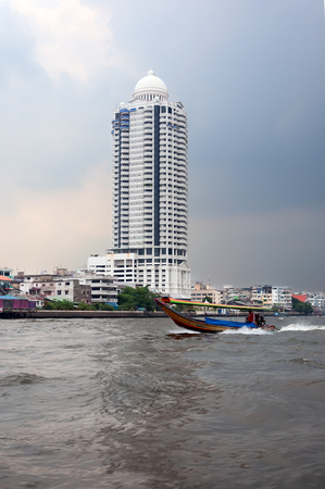 tower building at the navigable river on the background of a stormy skyの写真素材