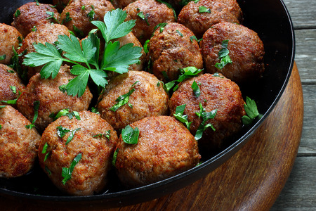 Fried pork meatballs in frying pan の写真素材